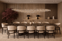 Luxury linear chandelier installed above grand dining table in a refined interior setting