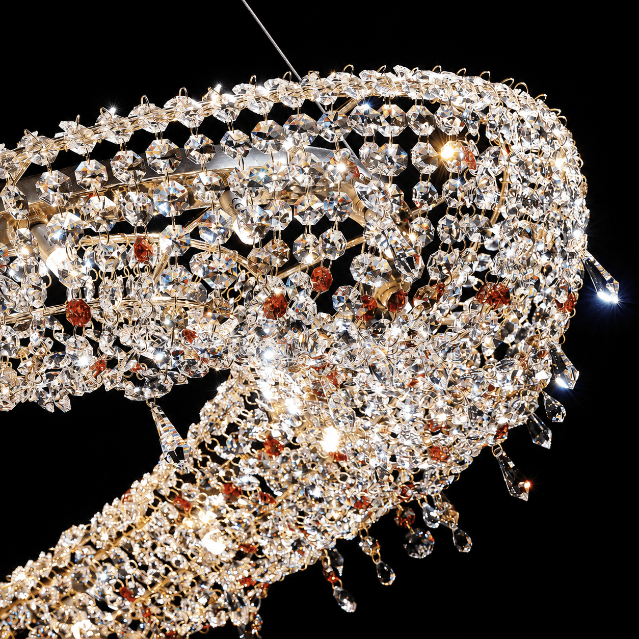 Close-up of precision-cut Asfour crystal and 18K gold-plated copper on the Aurelio Wave Oval chandelier.