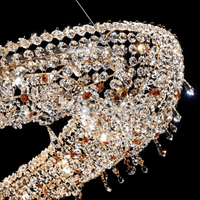 Close-up of precision-cut Asfour crystal and 18K gold-plated copper on the Aurelio Wave Oval chandelier.