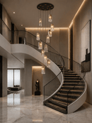 Aurora Lava staircase chandelier in luxury double-height foyer with curved marble staircase and warm ambient lighting