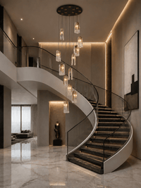 Aurora Lava staircase chandelier in luxury double-height foyer with curved marble staircase and warm ambient lighting