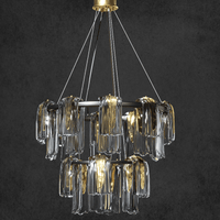 Aurora Maestra double-tier chandelier with brass frame and smoky Murano-style glass ribbons against a dark grey backdrop.