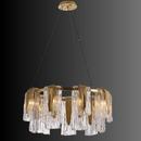 Aurora Sublime chandelier on a dark grey backdrop showing layered glass panels and brass structure for luxury contemporary interiors.