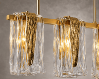 Close-up of Aurora Vellum Murano style glass chandelier with sculpted brass detailing and handcrafted art glass