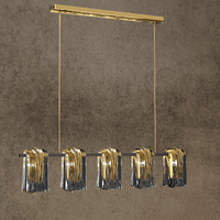 Close angled view of Aurora Vellum chandelier highlighting sculpted Murano-style glass folds and brushed brass bar.