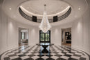 Bel Air monumental crystal chandelier installed in a two-story foyer with a circular gallery and checkerboard floor.
