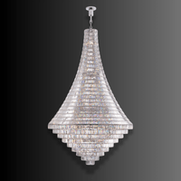 Bel Air large crystal chandelier in polished stainless steel, shown against a dramatic black-to-grey background.