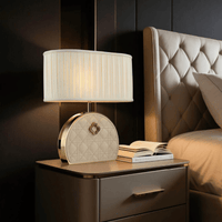 Bellmont luxury bedside table lamp styled in a modern bedroom, showcasing quilted leather craftsmanship.