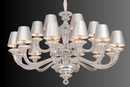 Close-up of Cadogan chandelier showing optical crystal arms and tailored ivory fabric shades