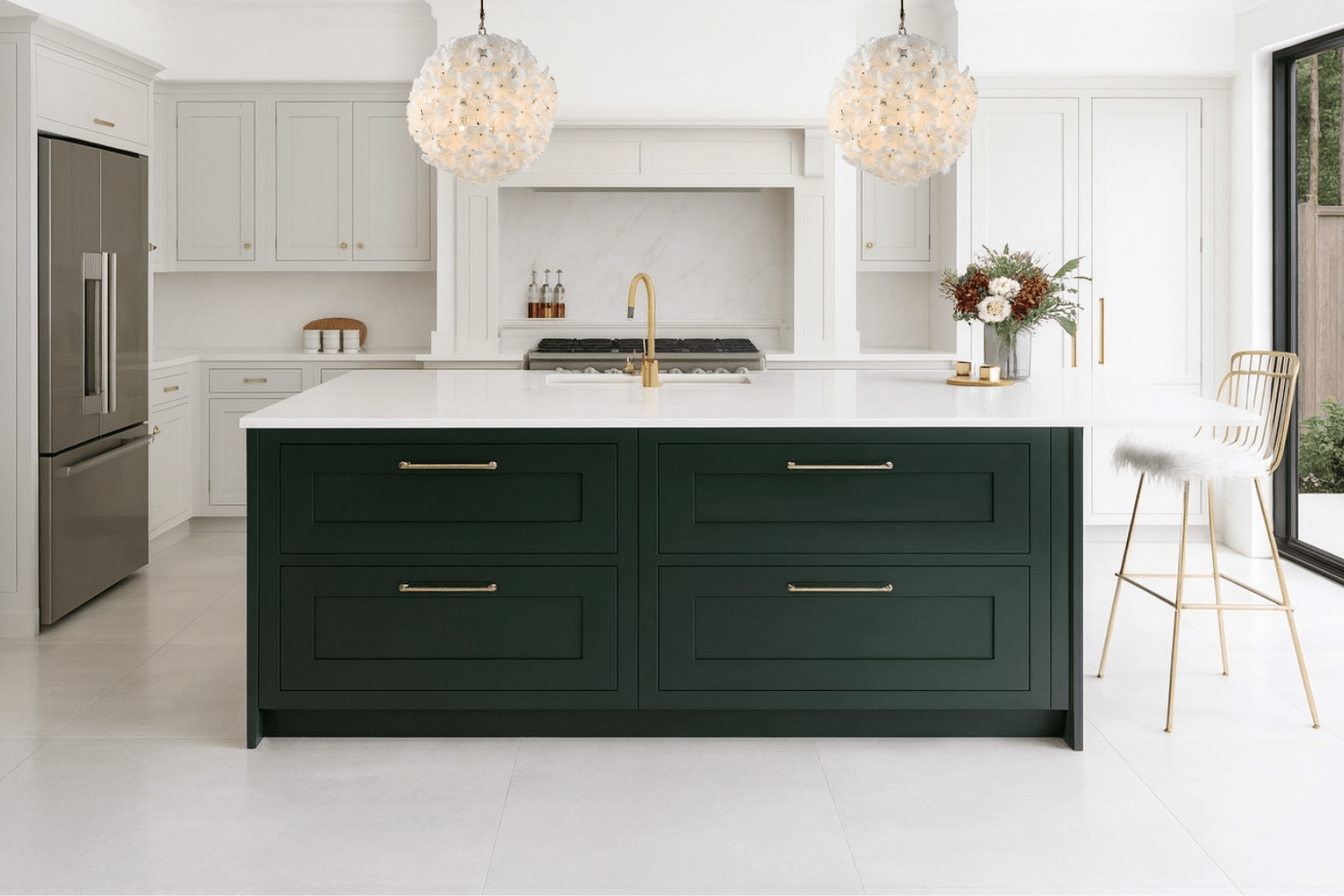 Pair of Camellia Fiorita Globe chandeliers above a modern kitchen island in white and brass.
