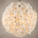 Close-up of Camellia Fiorita Globe chandelier with hand-blown white floral glass and warm light.