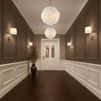 Two Camellia Fiorita Globe chandeliers lighting a classic hallway with panelled walls.