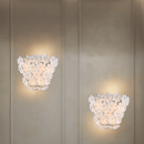 Pair of Murano-style floral wall sconces illuminating a luxury interior wall.