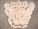 Close-up of Camellia Fiorita floral wall sconce with illuminated Murano-style glass petals