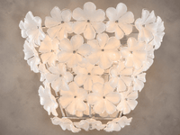 Close-up of Camellia Fiorita floral wall sconce with illuminated Murano-style glass petals