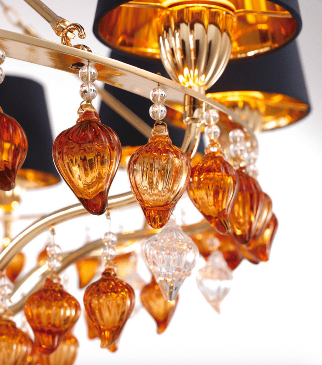 Close-up of Murano-style amber glass drops and gold detailing on the Donatello Eleganza chandelier by HDLS.