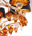 Close-up of Murano-style amber glass drops and gold detailing on the Donatello Eleganza chandelier by HDLS.