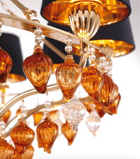 Close-up of Murano-style amber glass drops and gold detailing on the Donatello Eleganza chandelier by HDLS.