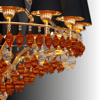 Close-up of Murano-style amber glass drops and gold-plated copper detailing on the Donatello Imperiale chandelier by HDLS.
