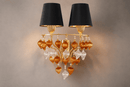 Close-up of Donatello Regal Glow wall lamp with black shades, gold metalwork and sculpted glass drops