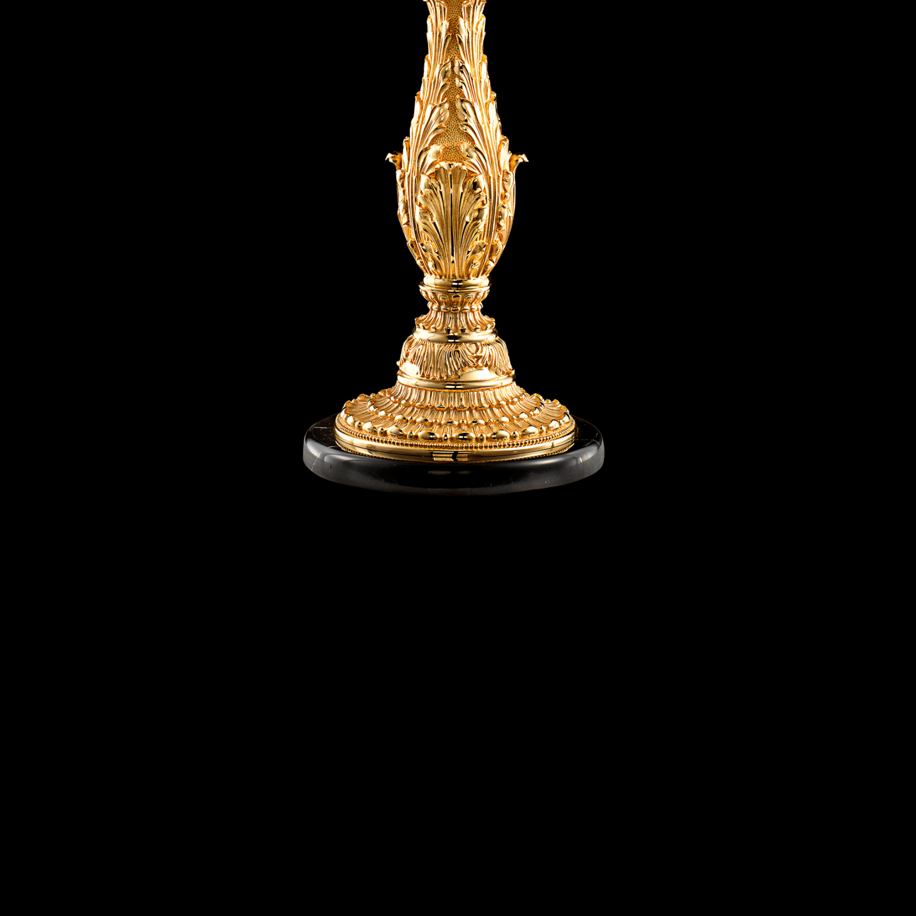 Close-up of decorative base in 24K gold-plated copper with classical French ornament detail