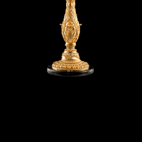Close-up of decorative base in 24K gold-plated copper with classical French ornament detail