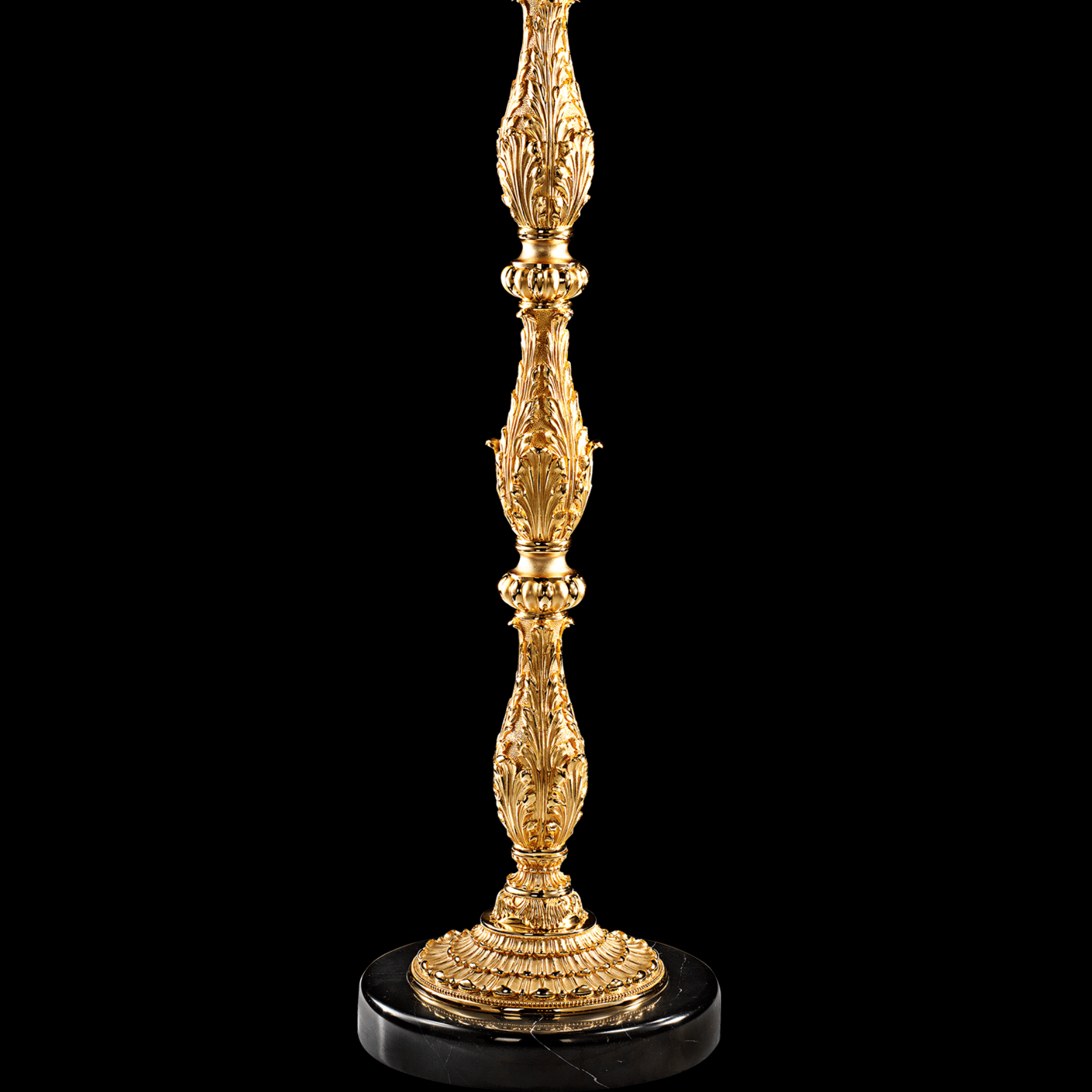 Detailed view of sculpted Empire-style column and black marble base on luxury floor candélabre