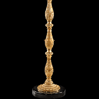 Detailed view of sculpted Empire-style column and black marble base on luxury floor candélabre