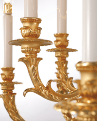 Close-up of hand-finished 24K gold-plated copper arm detailing in French Empire chandelier design.
