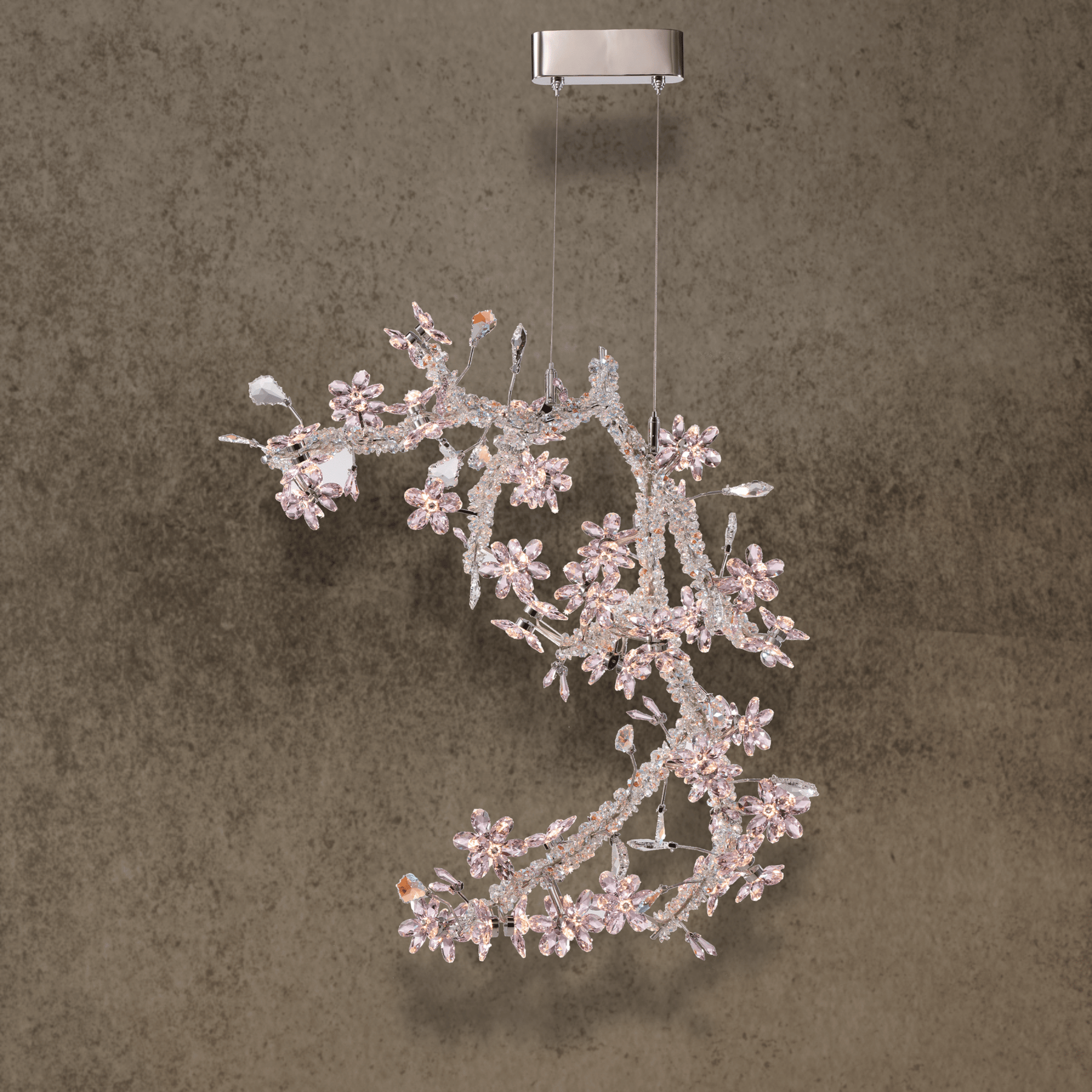 Luxury sculptural chandelier featuring Swarovski crystal composition and stainless steel structure designed for refined interiors
