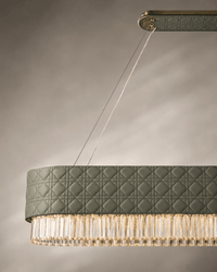 Close-up of Florence Trapunto Ardesia linear chandelier in sage quilted leather and clear crystal