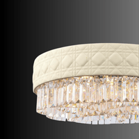 Close-up of the Florence Trapunto Avorio chandelier showing quilted Italian leather craftsmanship and premium Asfour crystal prisms.