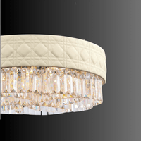 Close-up of Florence Trapunto Neve chandelier showing Asfour crystals and quilted leather band.