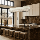Florence Trapunto Neve chandelier above a luxury kitchen island with marble and gold accents.