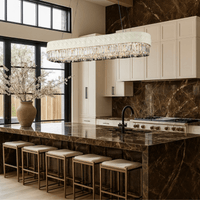 Florence Trapunto Neve chandelier above a luxury kitchen island with marble and gold accents.