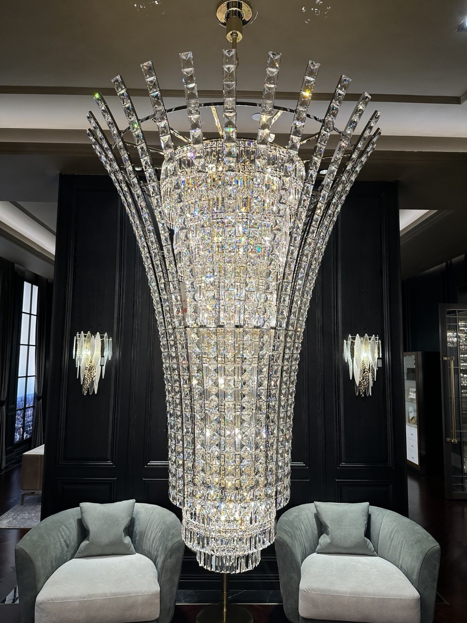 Reinforced suspension and load-bearing design of a grand scale chandelier installed in a double-height architectural interior.