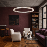 Halo Luxe Seraphina crystal chandelier installed in a modern living room with warm decor, showcasing halo illumination.