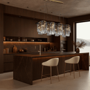 Aurora Magma linear brass chandelier above an elegant marble kitchen island in a high-end contemporary interior.