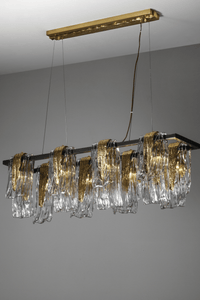 Side-angle view of Aurora Magma chandelier showing sculpted Murano-style glass folds and polished brass frame details.