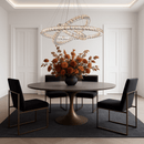 Halo Luxe Astraea crystal chandelier suspended above a designer dining table, illuminating the space with multi-ring LED lighting.