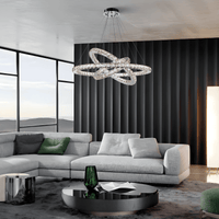Halo Luxe Astraea crystal chandelier installed in a modern grey living room, showcasing its floating multi-ring LED design.