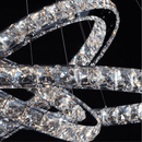 Close-up detail of the Halo Luxe Astraea chandelier showing precision-cut crystals and polished stainless steel rings.