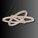 Modern three-ring Halo Luxe Astraea crystal chandelier shown on a dark background highlighting its reflective LED glow.