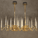 Gala chandelier by HDLS in front of a light brown background with light on