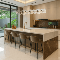 Modernus Linear chandelier installed above a luxury kitchen island with marble finishes, warm lighting.