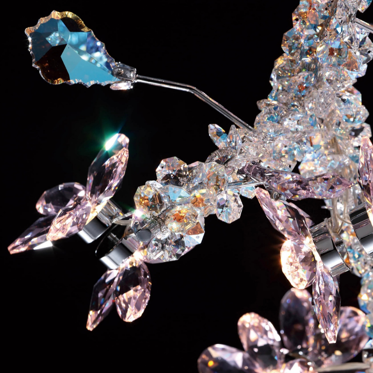 Close-up of an HDLS modern chandelier featuring shimmering Swarovski crystals with intricate sculptural detailing.