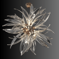 Gold-finish Helios sunburst chandelier featuring sculpted Murano-style glass blades displayed on a dark background.