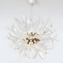 Helios sunburst chandelier displayed on a white background, highlighting sculptural glass blades and warm LED core.