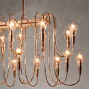 Close-up of the Hyperion Lumina rose gold linear chandelier with sculptural crystal candle-style lights