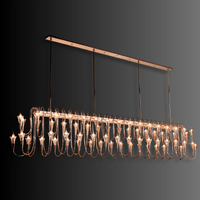 Illuminated Hyperion Lumina linear brass chandelier with crystal, designed for long dining tables and grand interiors.